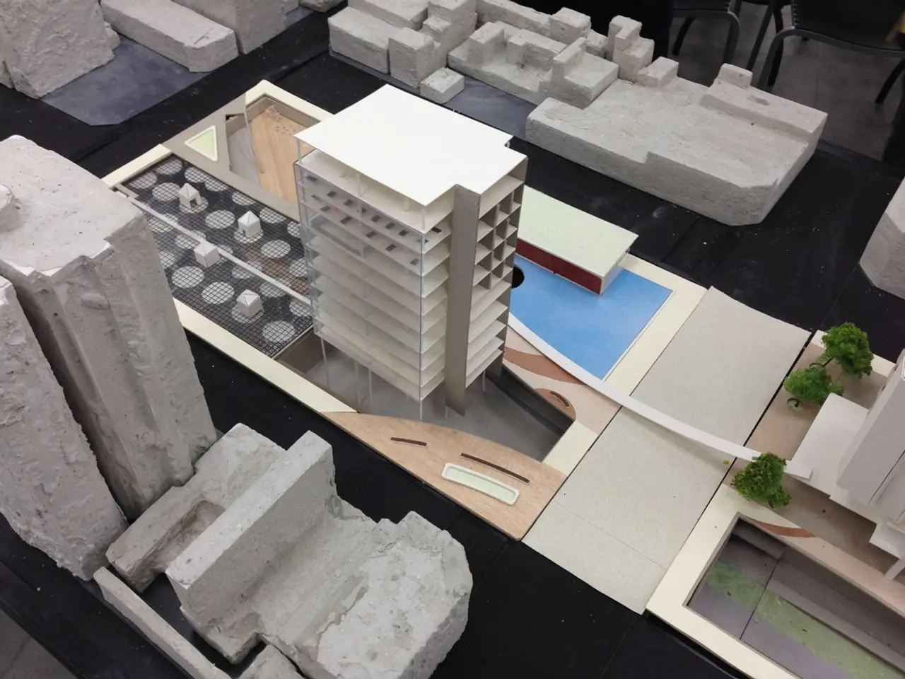 In this picture we can see the small architecture model of the building and some stones.