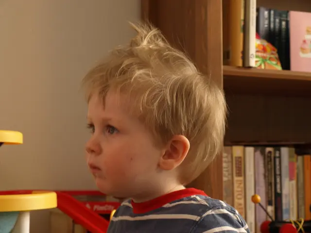 In this picture we can see a kid in the front, on the right side there is a rack, we can see some...