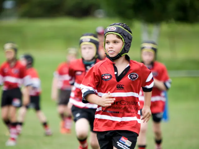 In this image there are group of kids running on the ground by wearing the red color dress and...