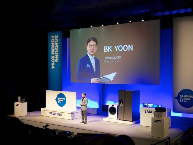 At the bottom of the picture, we see people are sitting on the chairs. In front of the picture, we...